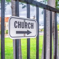 Panorama frame Church sign with arrow outdoors on a sunny day Panorama frame Church sign with arrow outdoors on a sunny day